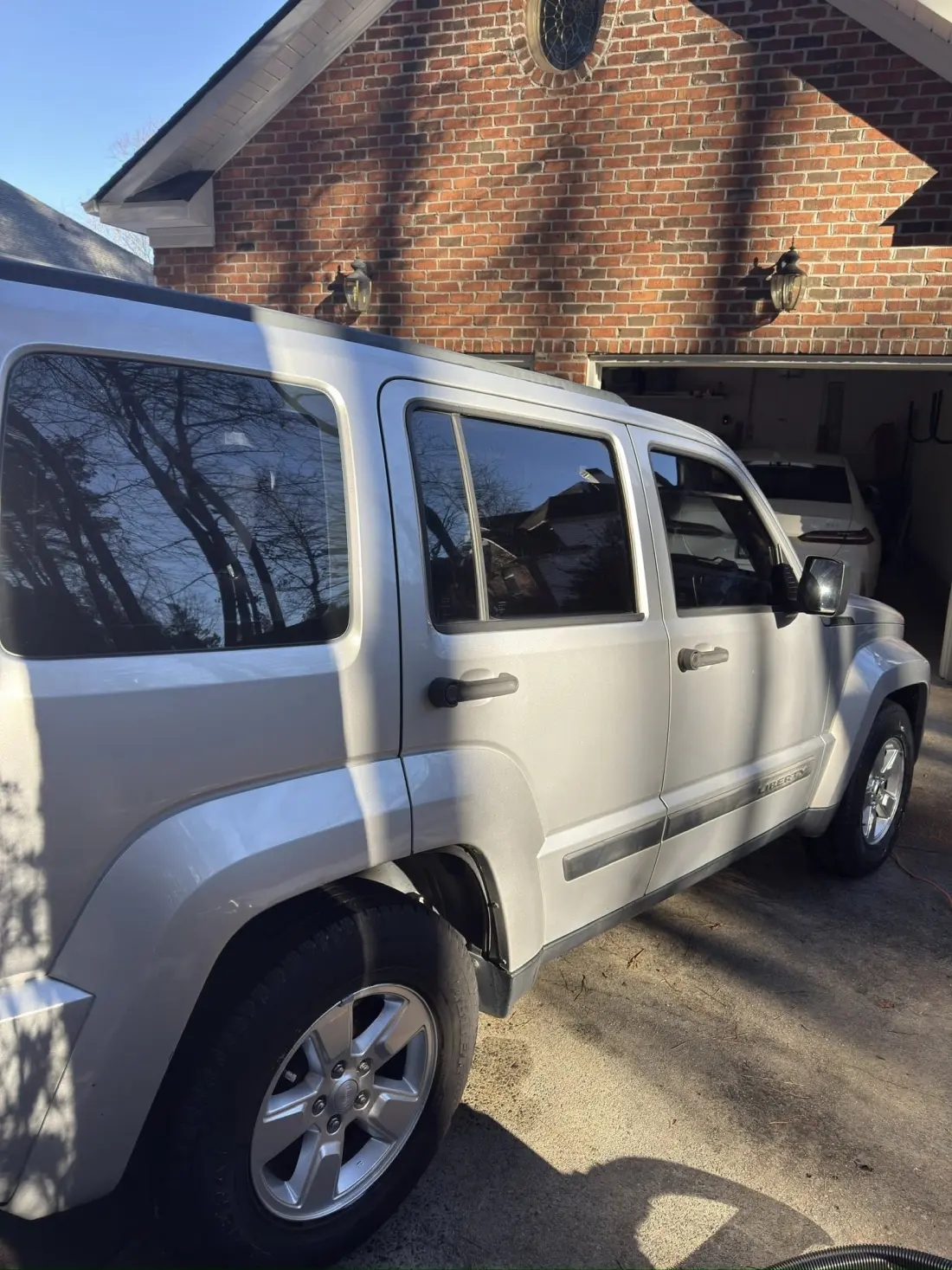 Silver Jeep Liberty covered in foam cannon pre-wash, professional auto detailing in Hickory NC